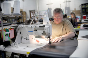 Employee sewing industrial grade fabrics